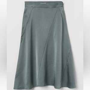 Cute silky greenish skirt, only wrinkled from being folded, never worn